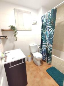 a bathroom with a toilet and a sink and a shower at Apartamento Puerto Chico in El Puerto de Santa María