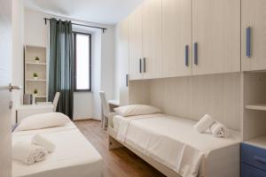 Postel nebo postele na pokoji v ubytování Elegante rifugio D'Annunzio con parcheggio a Trieste