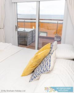 a bedroom with a bed with a view of a balcony at Plover 2 - The Cove in Brixham