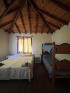 a bedroom with two beds and a window at Calida cabaña in Ushuaia