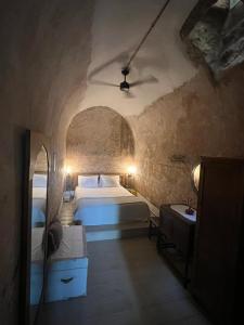 a bedroom with two beds in a stone room at Latmos 1860 in Skala