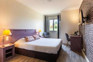 a hotel room with a bed and a window at Hôtel HAPY in Houdan