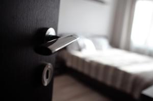 a door knob in a room with a bed at Central Place Apartment Timisoara in Timişoara