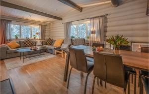 a living room with a table and a couch at Awesome Home In Slen With Sauna And 3 Bedrooms in Sälen