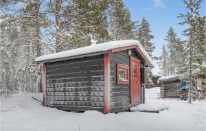 a small cabin with a red door in the snow at Awesome Home In Slen With Sauna And 3 Bedrooms in Sälen