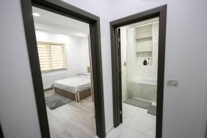 a bathroom with a door leading to a bedroom at AStar Apartments - LARGE in Rădăuţi
