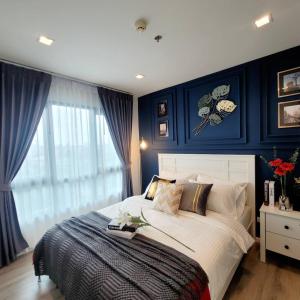 a bedroom with a large bed with blue walls at KnightsBridge BTS Bearing in Ban Khlong Samrong