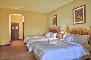a hotel room with two beds with white sheets at Chula Vista Condo Unit 2645 and 2647 Full Property in Wisconsin Dells