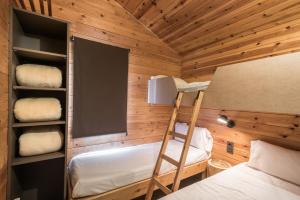 a room with a bunk bed and a ladder in a cabin at Bungalows Stel-Puigcerdà in Puigcerdà +50 photos