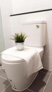 a white toilet with a plant on top of it at KnightsBridge BTS Bearing in Ban Khlong Samrong +27 photos