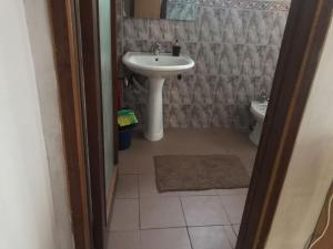 a bathroom with a sink and a toilet at Mance Apartment in Durrës