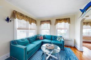 a living room with a blue couch and a table at Entire House 12 Street OceanBlock in Ocean City