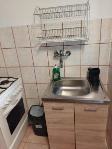 a small kitchen with a sink and a stove at Apartament/mieszkanie-Wałbrzych Piaskowa Góra in Wałbrzych