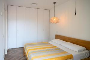 a bedroom with a bed with a striped blanket at Vetriera41 in Castelbuono