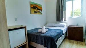 a bedroom with a bed with a stuffed animal on it at Casa Gladius in Jericoacoara +41 photos