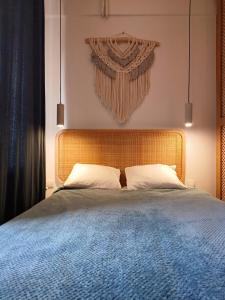 a bedroom with a large bed with a wooden headboard at Kowalska no 4 Apartment in Gdańsk