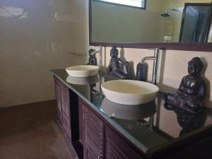 a bathroom with two sinks and a mirror at Melaya Beach Resort Queen Bed in Penginuman +8 photos