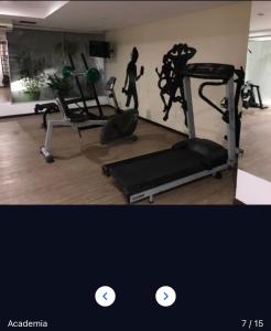 a gym with a treadmill and a woman walking in a room at Flat 406- Imperial Flat Tambaú NOBILE in João Pessoa