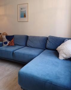 a blue couch sitting in a living room at Kowalska no 4 Apartment in Gdańsk