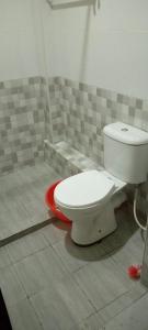 a bathroom with a toilet sitting on the floor at TRANGQUIL APARTMENTS in Kitengela 