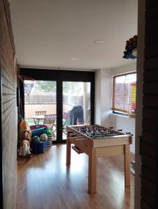a room with a foosball table in the middle of a room at SORIA todas las comodidades y más in Soria