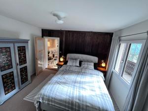 a bedroom with a bed and a window at Ferienhaus Vardaval - Schmitten / GR in Schmitten