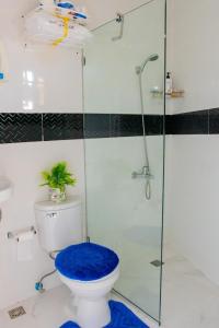 a bathroom with a toilet with a glass shower at Royal Terrace V (Duque) in San Felipe de Puerto Plata