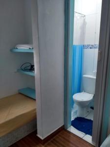 a bathroom with a toilet and a shower at Antonia Hospedaria 4 in Búzios