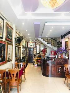 a restaurant with tables and chairs and a bar at Huế thương Hotel in Hue