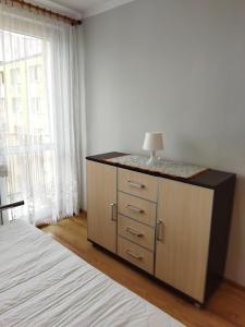 a bedroom with a dresser with a lamp on it at Apartament/mieszkanie-Wałbrzych Piaskowa Góra in Wałbrzych