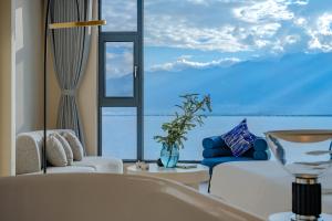 a living room with a view of the ocean at Dali Oriental Seaview Hotel -Dali Erhai in Dali
