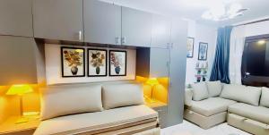 a living room with yellow walls and a white couch at استيديو علوى بورتو سعيد porto said Studio in a resort in `Ezbet Shalabi el-Rûdi