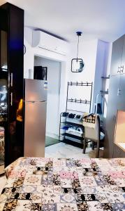 a kitchen with a refrigerator and a bed in a room at استيديو علوى بورتو سعيد porto said Studio in a resort in `Ezbet Shalabi el-Rûdi