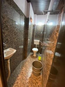 a bathroom with a sink and a toilet and a shower at Hotel khatu shyam palace in Ujjain