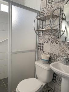 a bathroom with a toilet and a sink at Cabaña Familiar de Descanso y Paseo - Puyehue in Puyehue