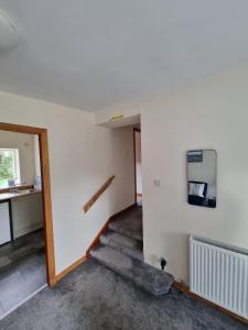 an empty room with a staircase in a house at Hillview in Inverness