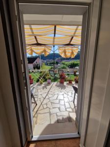 a door leading to a patio with a view of the yard at Rooms Marijeta in Skradin