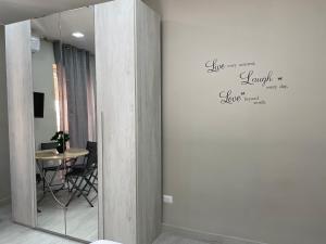a mirror in a room with a table and a dining room at Horus Home in Torre del Greco