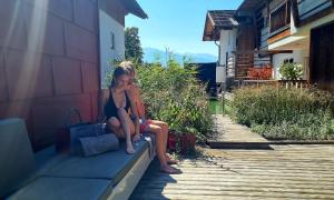 a girl in a bikini sitting on a ledge at Das Urgestein in Stans