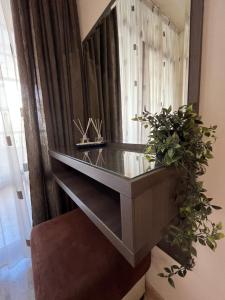 a glass counter in a room with a mirror at Room Iva in Sandanski