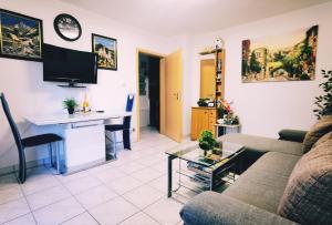 a living room with a couch and a table at Wohlfühloase in Birkenfeld