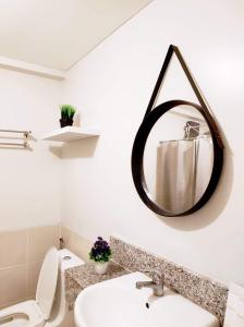 a bathroom with a sink and a mirror on the wall at VERDON PARC CONDOMINIUM in Davao City