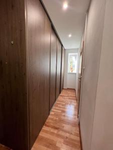 a hallway with wooden walls and a wooden floor at Apartman centrum Šturka in Martin