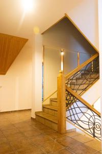 a spiral staircase in a house with a stair railing at Villa Szarotka in Dzianisz +26 photos