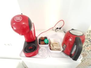 a red blender and a tea kettle on a table at Alicante Alive -Jorge Juan in Alicante