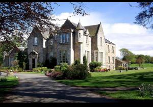 a large house with a driveway in front of it at Kilconquhar castle estate villa 6, 4 bed sleeps 10 in Fife