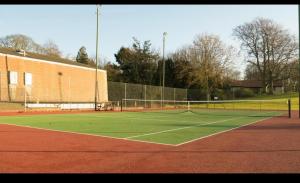 a tennis court with a net on top of it at Kilconquhar castle estate villa 6, 4 bed sleeps 10 in Fife