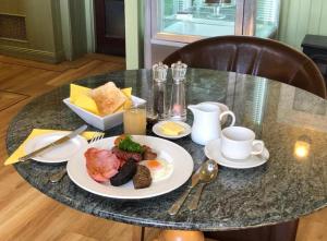 a table with a plate of breakfast food on it at Kilconquhar castle estate villa 6, 4 bed sleeps 10 in Fife