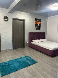 ein Schlafzimmer mit einem Bett, einer Tür und einem Teppich in der Unterkunft Sipotul Apelor in Domneşti