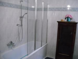 a bathroom with a shower and a bathtub with a glass door at Chez moi in Colleverde